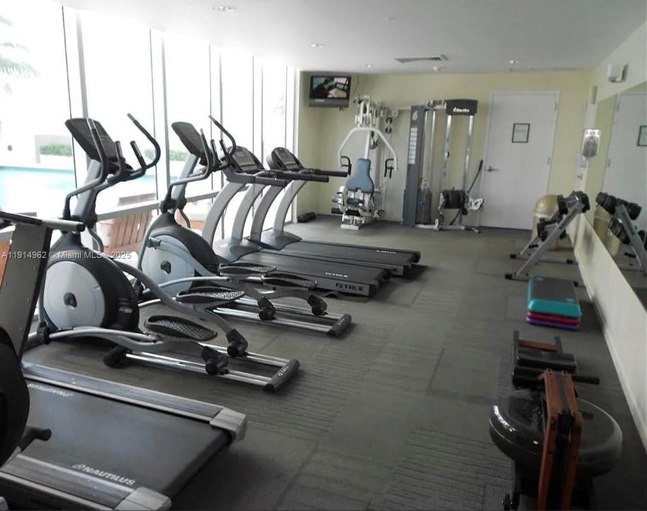 9066 Southwest 73rd Court, Unit 2101 Miami, FL 33156 - Photo 9 of 10 a view of a room with gym equipment