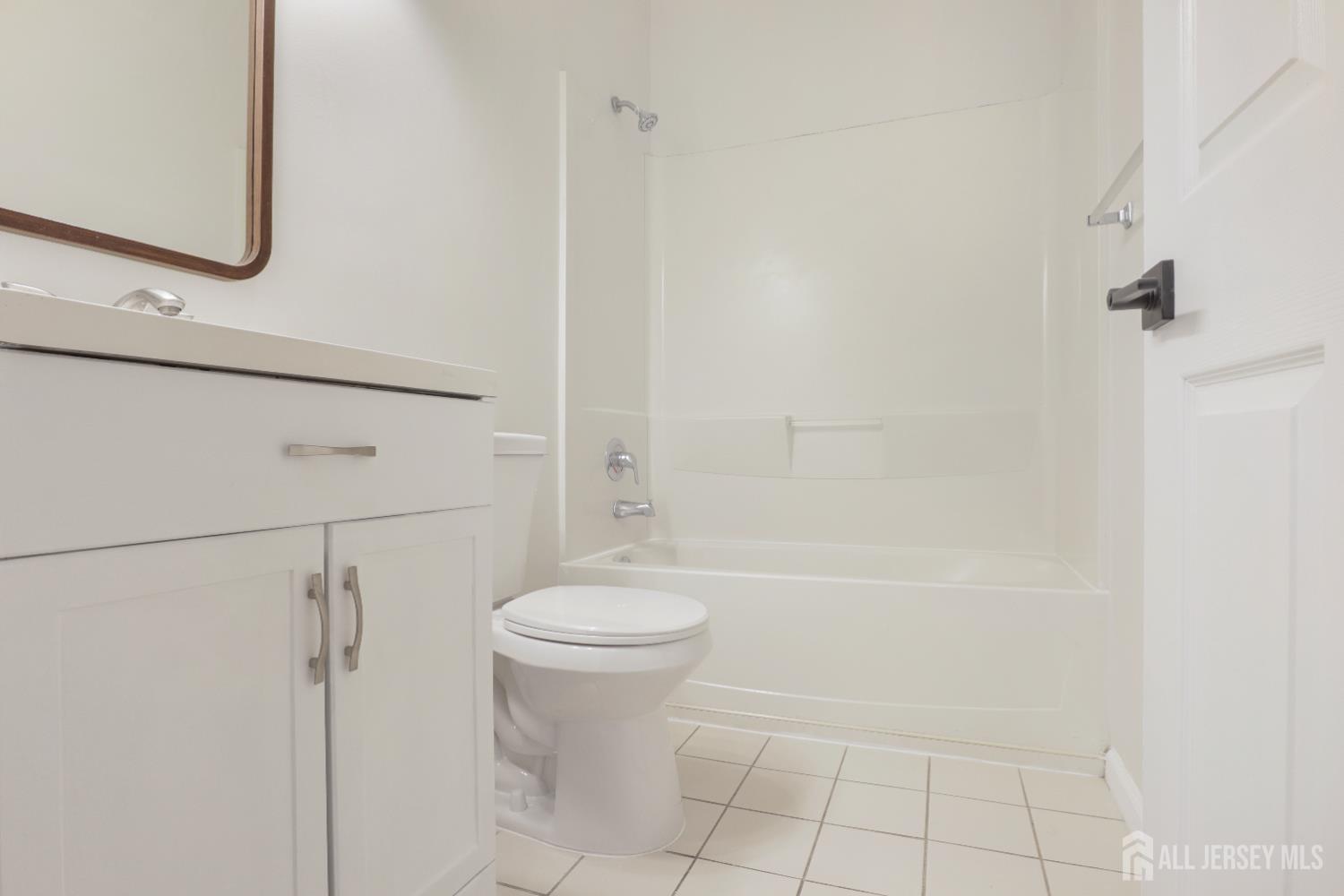 130B Remsen Avenue, Unit B New Brunswick, NJ 08901 - Photo 12 of 29 a bathroom with a bathtub a toilet and a shower
