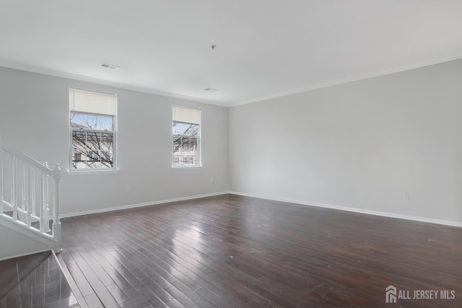 130B Remsen Avenue, Unit B New Brunswick, NJ 08901 - Photo 6 of 29 a view of an empty room with wooden floor and a window