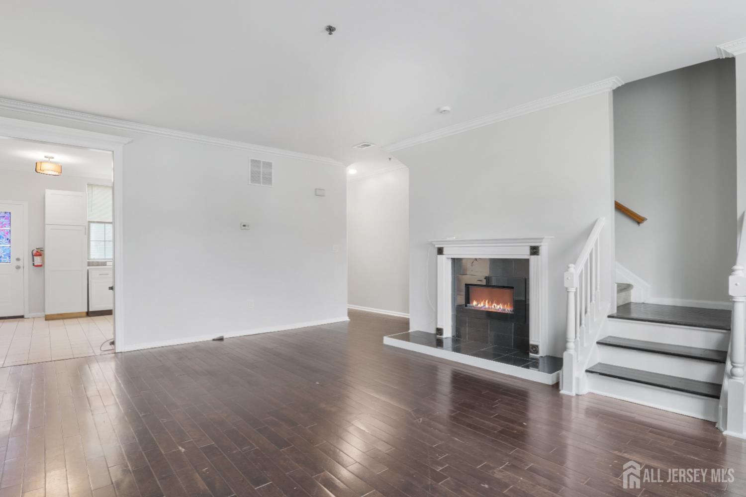 130B Remsen Avenue, Unit B New Brunswick, NJ 08901 - Photo 8 of 29 an empty room with wooden floor and fireplace
