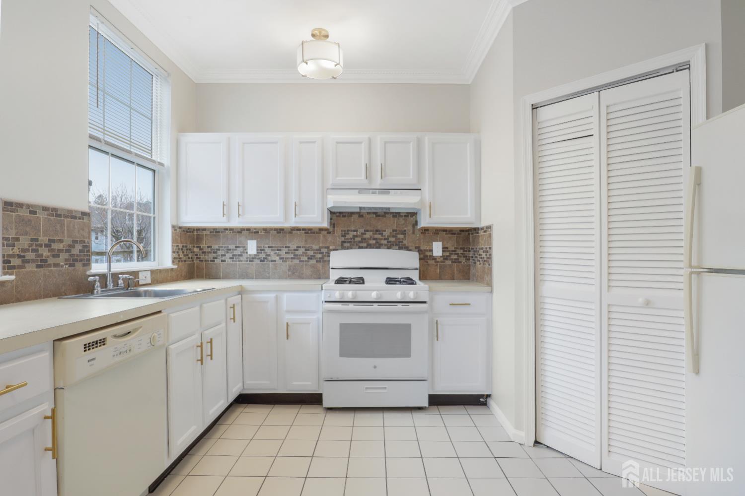 130B Remsen Avenue, Unit B New Brunswick, NJ 08901 - Photo 10 of 29 a kitchen with white cabinets and white appliances