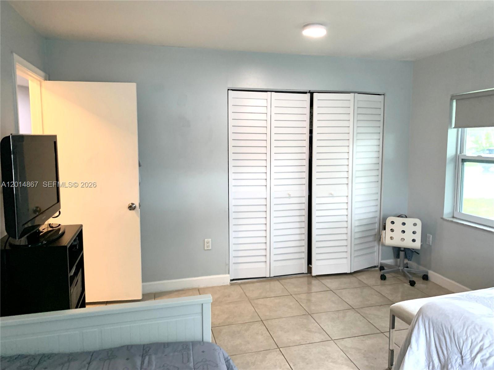 4904 Southwest 139th Court Miami, FL 33175 - Photo 12 of 20 a view of a livingroom with an empty space and a window