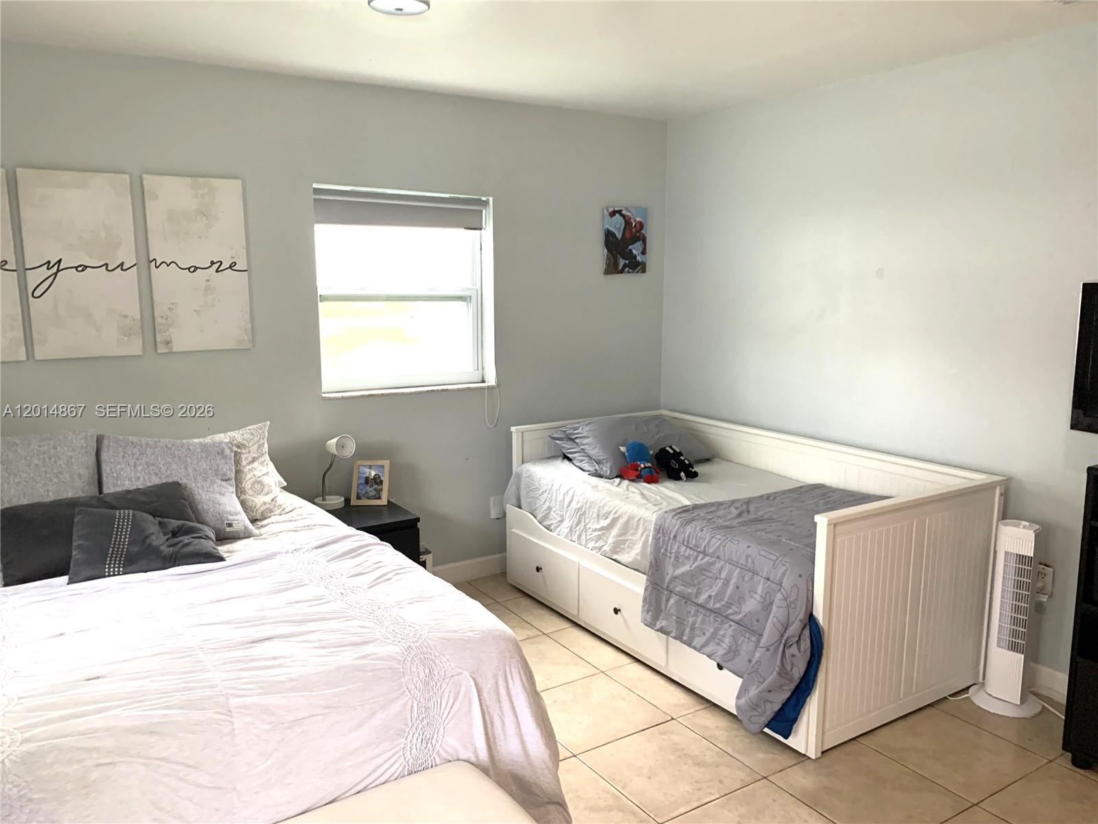 4904 Southwest 139th Court Miami, FL 33175 - Photo 14 of 20 a bedroom with a bed and window