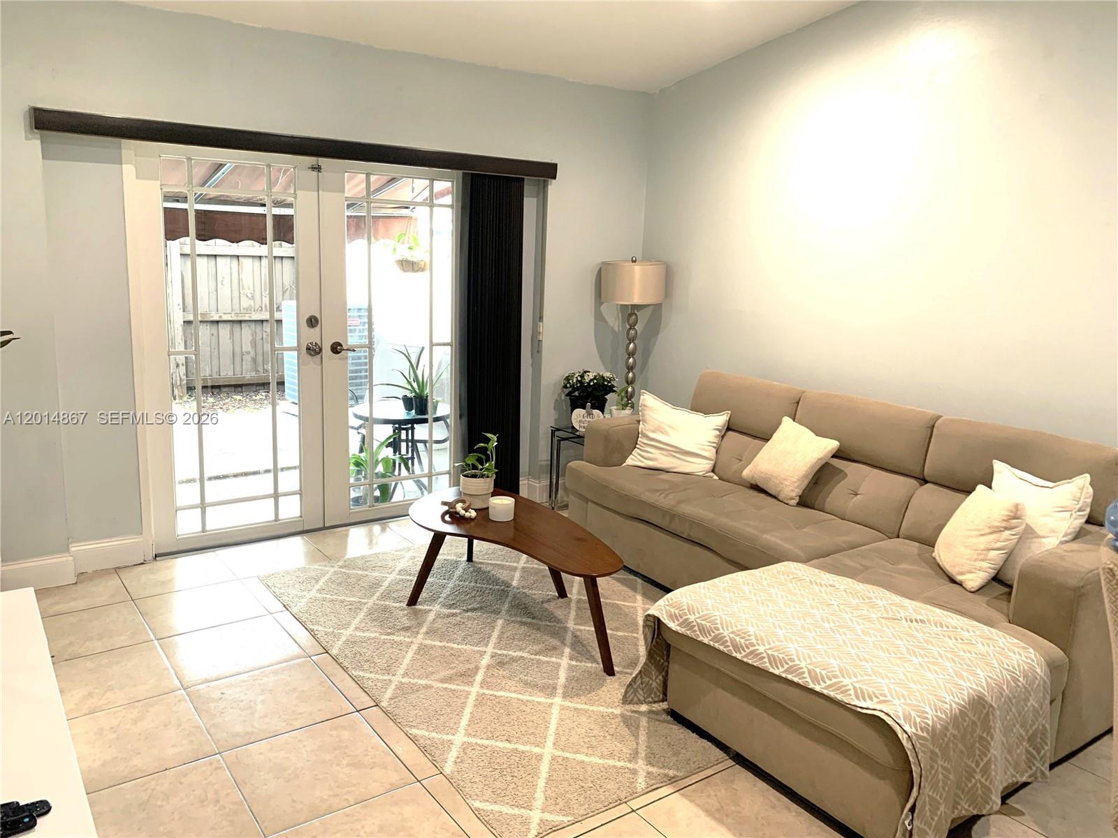 4904 Southwest 139th Court Miami, FL 33175 - Photo 4 of 20 a living room with a couch and a table in it