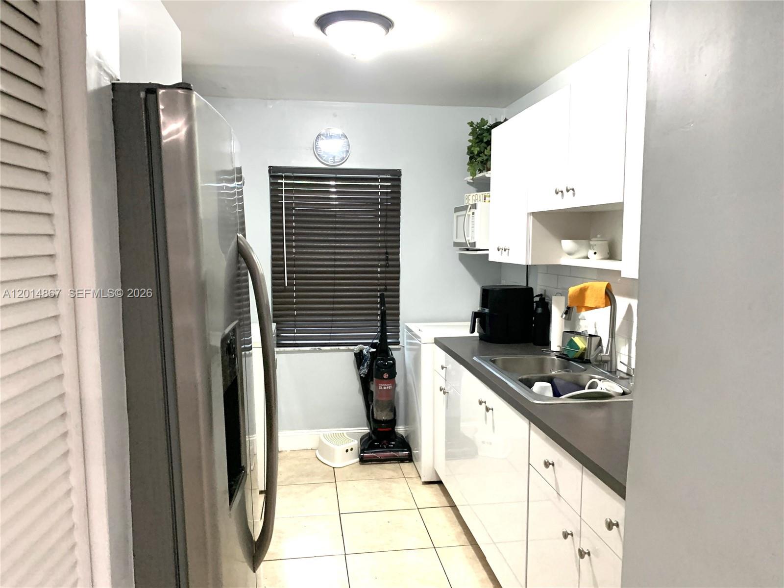 4904 Southwest 139th Court Miami, FL 33175 - Photo 6 of 20 a kitchen with a refrigerator and a stove