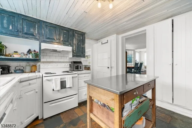 a kitchen with stainless steel appliances granite countertop a stove and a sink