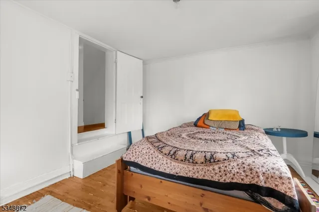 a bedroom with a bed and dresser