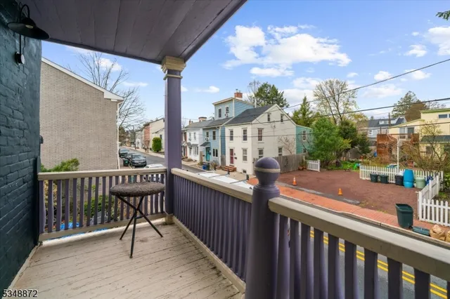 a balcony with wooden floor and city view
