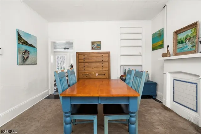 a dining room with furniture and a fireplace