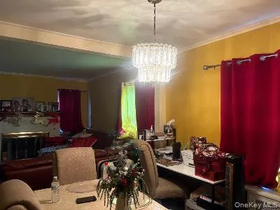a view of a room with dining table chairs and chandelier