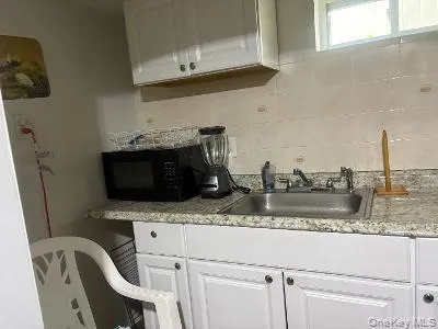 a kitchen with a sink cabinets and appliances