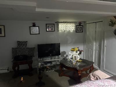 980 Wallace Avenue Baldwin, NY 11510 - Photo 10 of 10 a living room with furniture and a fireplace