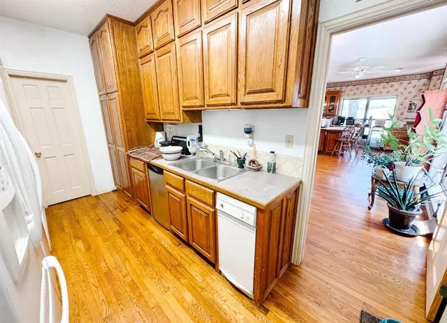 a dining room with stainless steel appliances kitchen island granite countertop a table and chairs