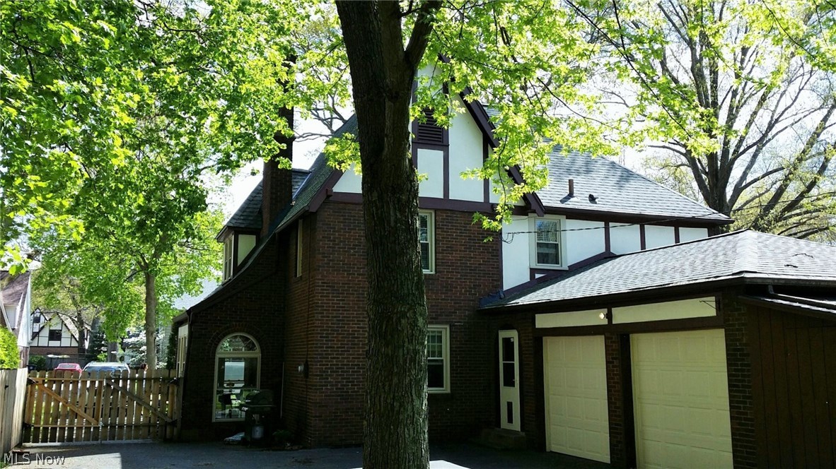 293 Sundale Road Akron, OH 44313 - Photo 20 of 20 The rear view of the home. Fully fenced back yard. New garage doors. Storage shed. Access to the porch and home. Notice the new multi-dimensional shingles roof? Call today to schedule a private showing.