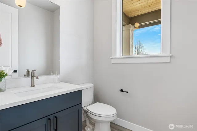 a bathroom with a sink a toilet and mirror
