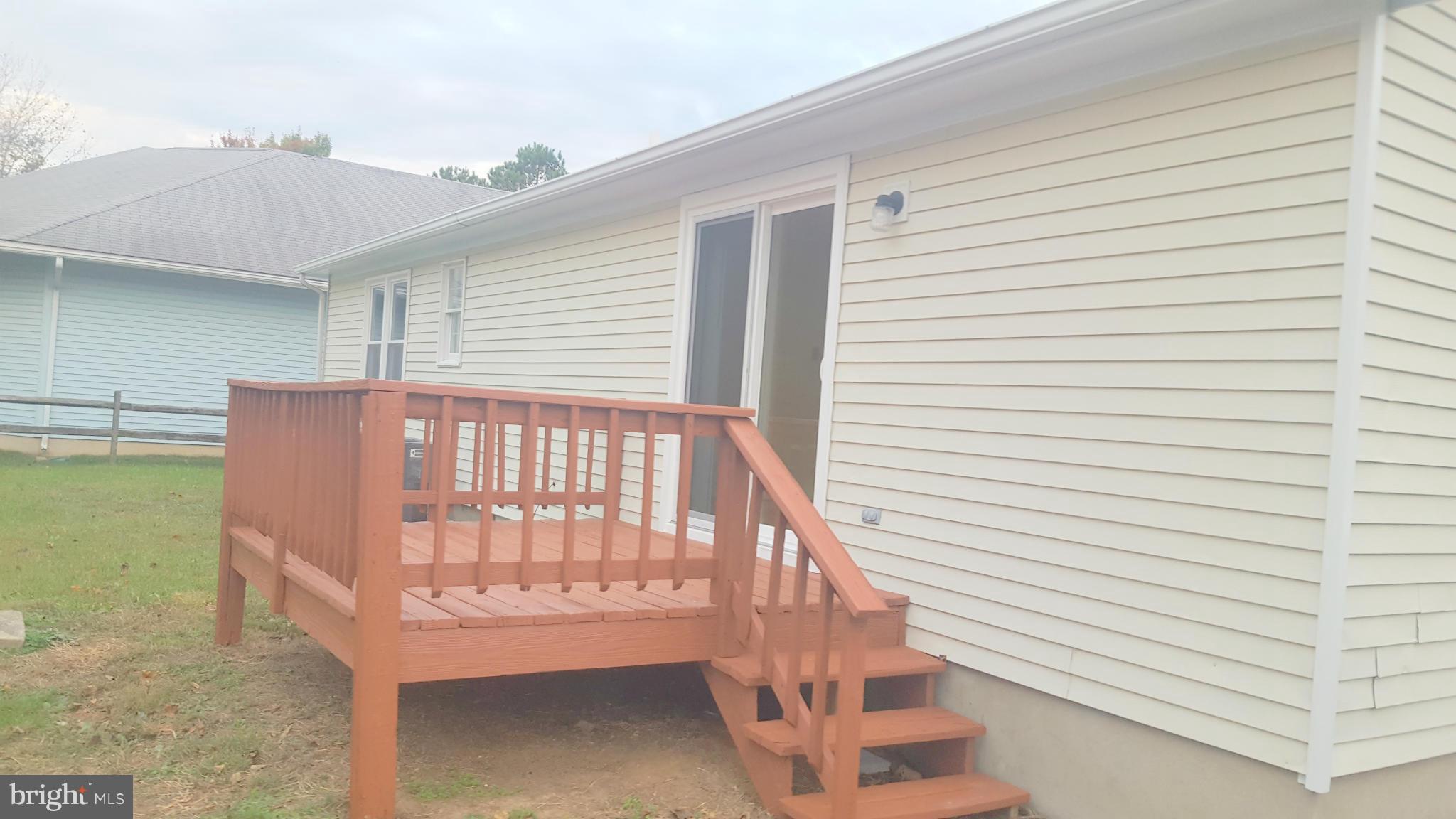 927 Crystal Rock Road Lusby, MD 20657 - Photo 13 of 30 a view of a porch with a bench