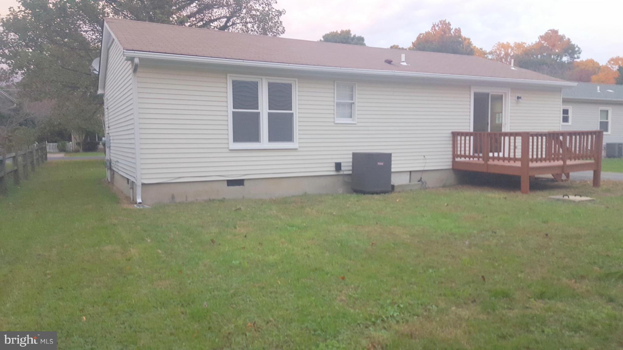 927 Crystal Rock Road Lusby, MD 20657 - Photo 23 of 30 a backyard of a house with table and chairs