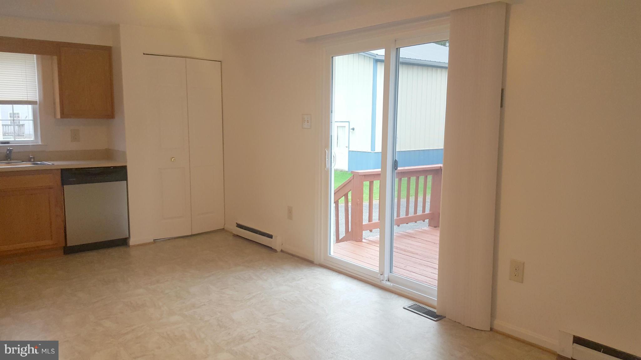927 Crystal Rock Road Lusby, MD 20657 - Photo 5 of 30 a view of an empty room with a fireplace and a window