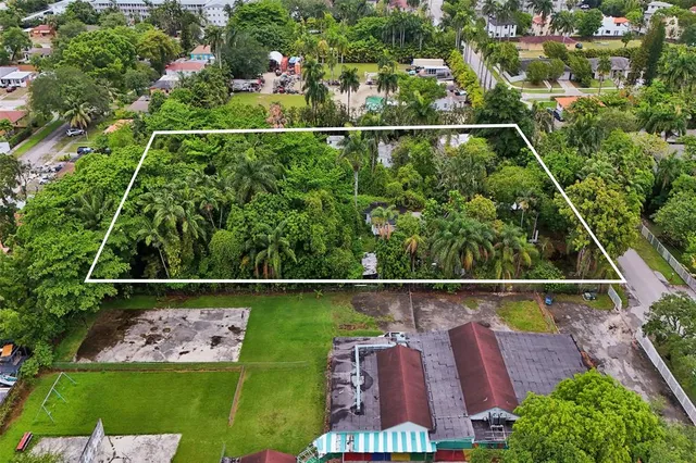 an aerial view of house with a yard