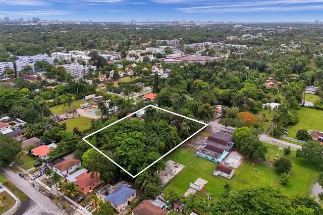an aerial view of lake and residential houses with outdoor space