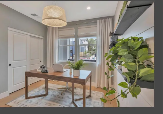a workspace with furniture and a potted plant