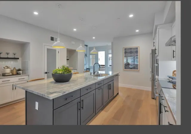 a kitchen with sink cabinets and living room