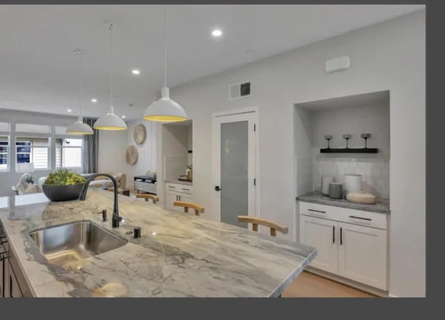 a kitchen with counter top space sink and refrigerator