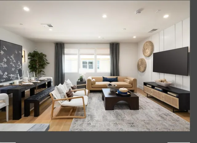 a living room with lots of furniture and a flat screen tv