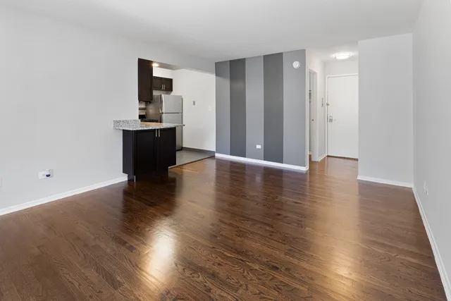 a view of a kitchen with wooden floor