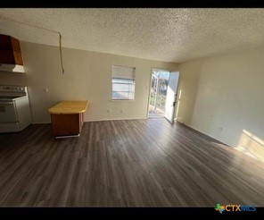 410 Veterans Avenue, Unit 5 Copperas Cove, TX 76522 - Photo 2 of 7 a view of a room with wooden floor and furniture