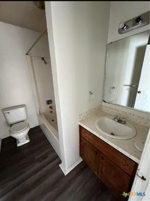 a bath room with a sink and a mirror