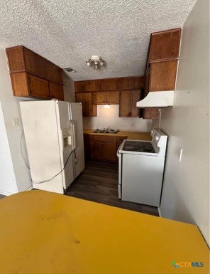 410 Veterans Avenue, Unit 5 Copperas Cove, TX 76522 - Photo 6 of 7 a kitchen with stainless steel appliances a refrigerator a sink a stove and white cabinets