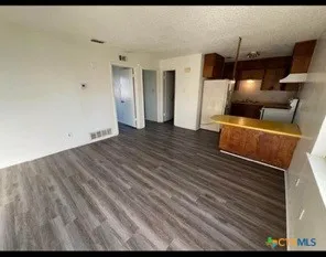 a view of room with wooden floor