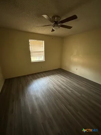 a view of an empty room and a window