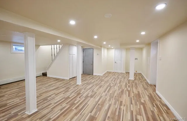a view of an empty room with wooden floor
