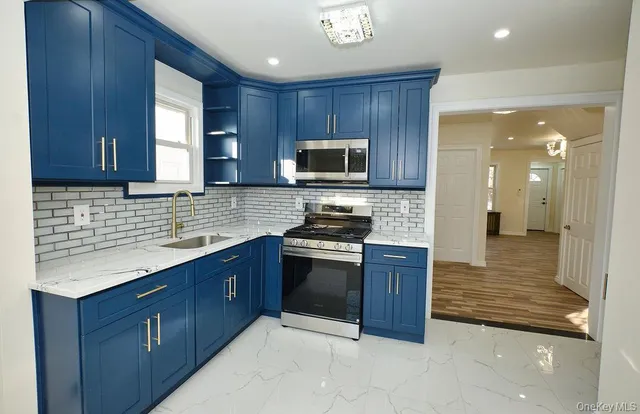 a kitchen with stainless steel appliances granite countertop wooden cabinets a stove top oven a sink and dishwasher