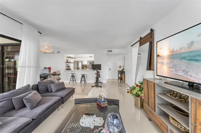 a living room with furniture fireplace and a large window