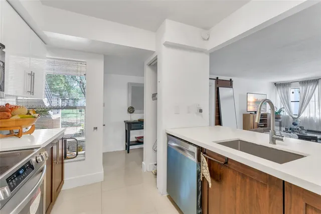 a view of a kitchen with workspace and a window