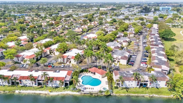 an aerial view of a house with a garden and trees