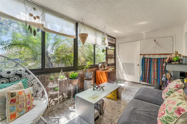 a bedroom with furniture and a large window