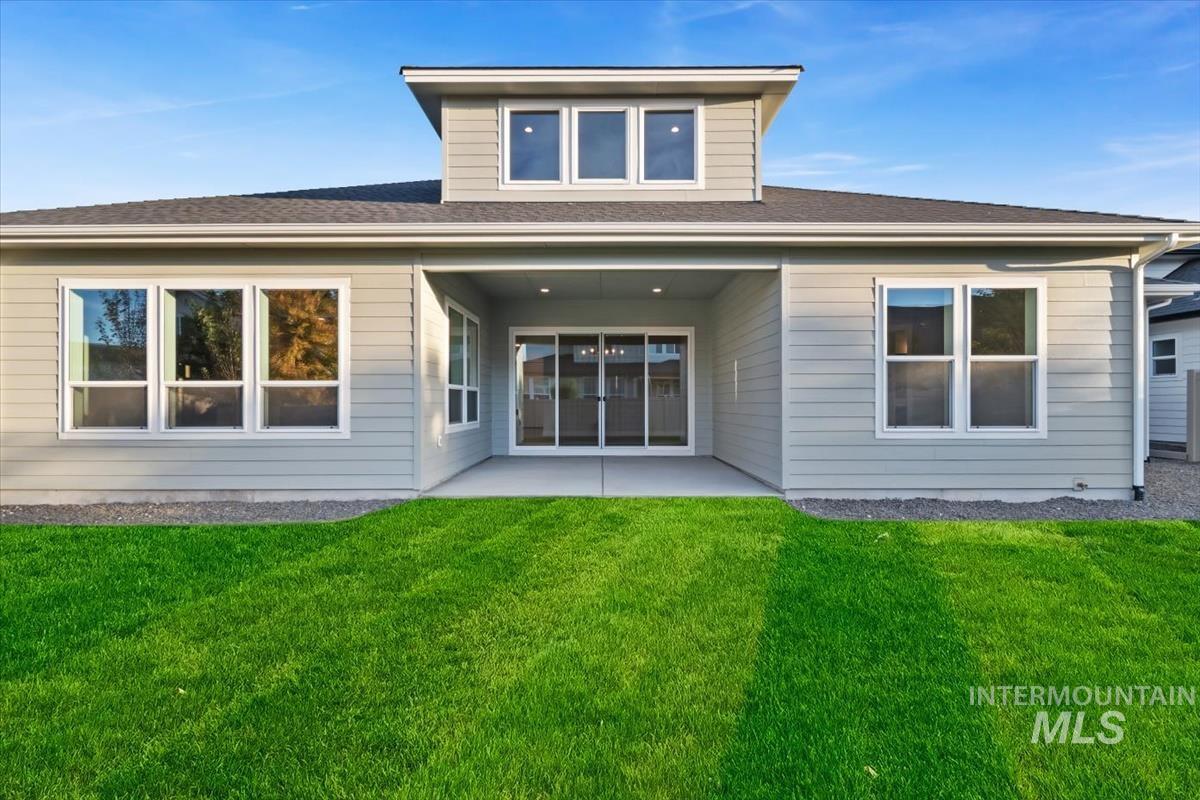 2147 East Blakehurst Avenue Kuna, ID 83634 - Photo 41 of 43 Rear view of property featuring a patio, a yard, and roof with shingles