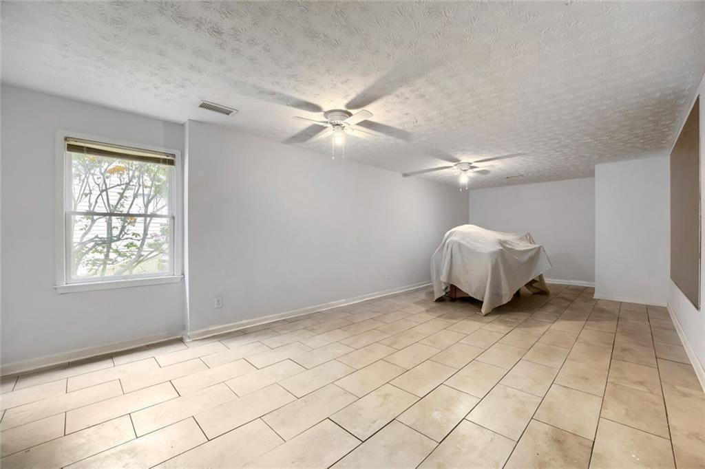 2128 Cluster Lane Grayson, GA 30017 - Photo 25 of 40 a view of a livingroom with a chandelier fan and a window
