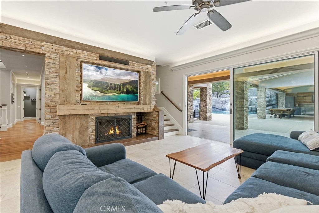 29131 Bouquet Canyon Road Silverado, CA 92676 - Photo 18 of 74 Open concept family room with large feature fireplace and backyard views. Staircase access to west wing for multi generation living