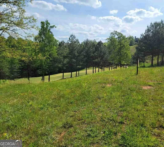 a view of lawn chairs and iron fence