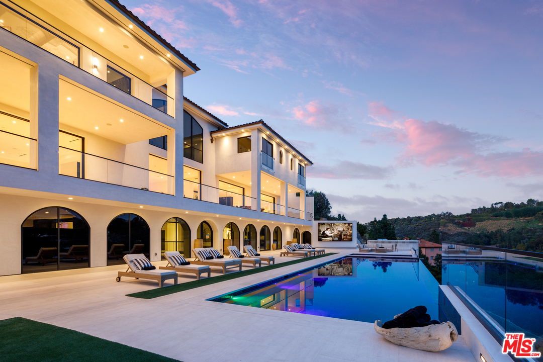 10697 Somma Way Los Angeles, CA 90077 - Photo 2 of 25 a view of pool with lawn chairs and a yard