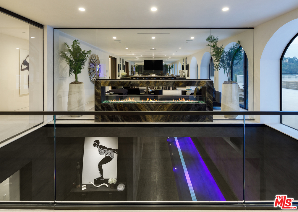 10697 Somma Way Los Angeles, CA 90077 - Photo 20 of 25 a living room with stainless steel appliances furniture and a painting on the wall