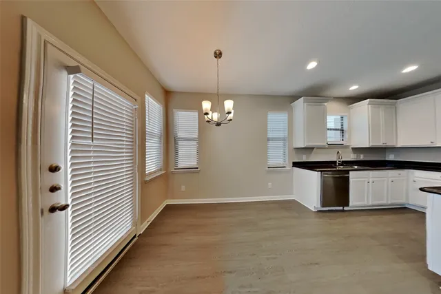 a kitchen with a refrigerator and ceiling cabinets