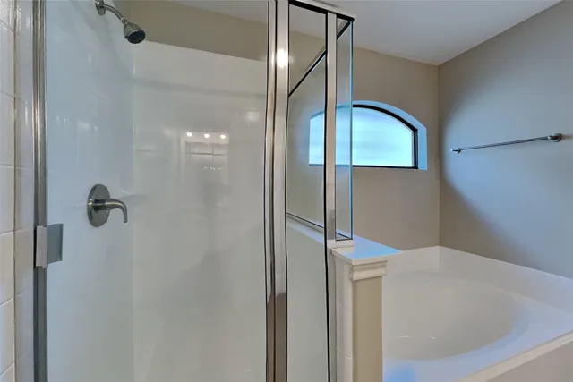 a bathroom with a shower and a mirror