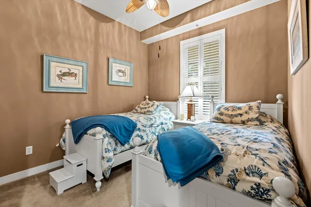 a bedroom with two beds and a window