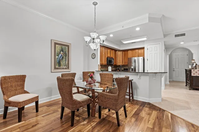 a view of a dining room with furniture and a chandelier